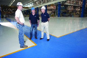 The management team at Healy, Long & Jevin stands on a recently completed industrial floor project where the company's place and finish crew installed superflat floors by hand, reaching FF and FL numbers well beyond specifications.