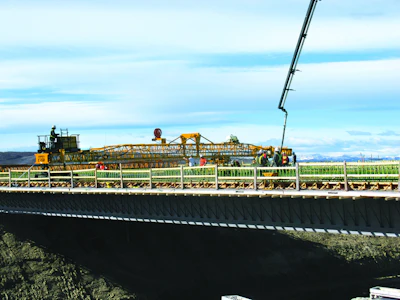Graham Group Ltd.’s new GOMACO C-450 finisher with transitional framework was put to work right away on Highway 2 just north of Calgary. The project involved placement of 620 cu. yds. of silica-fume concrete on side-by-side bridges.