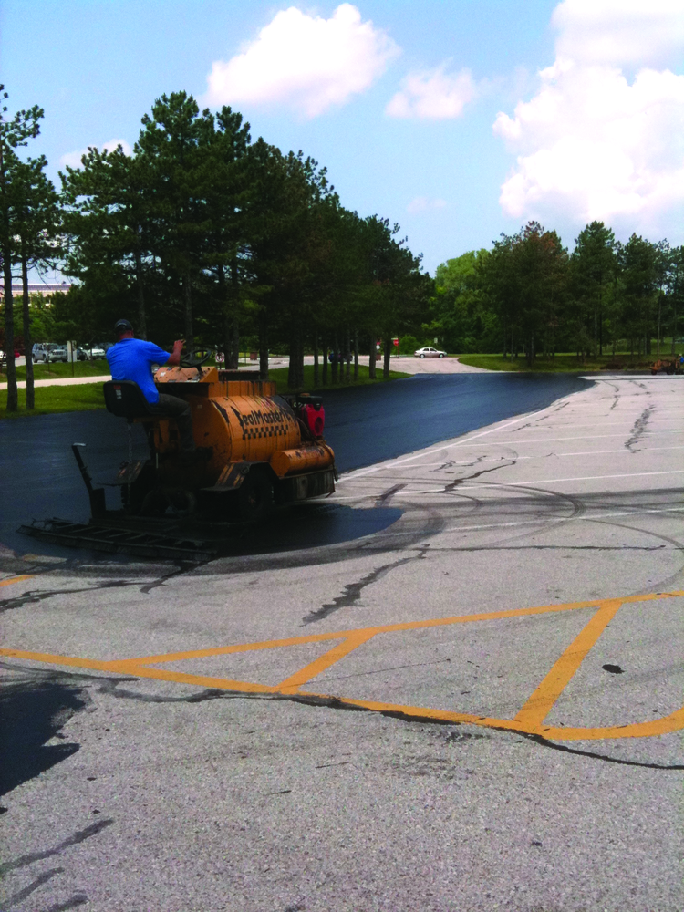 The parking lots were sealed using two SealMaster SP 300 squeegee machines which Sonnenberg outfitted with custom-made 18- to 24-in. brooms on the back of the units.