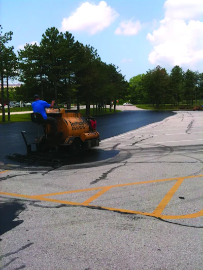 The parking lots were sealed using two SealMaster SP 300 squeegee machines which Sonnenberg outfitted with custom-made 18- to 24-in. brooms on the back of the units.