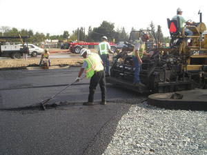 An opened-graded hot mix asphalt surface is constructed on the aggregate base. Note how the aggregate in the base is larger and more loosely compacted than a traditional base.