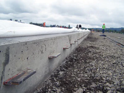 Steel plate dowels carry loads across a construction joint, maintain vertical alignment between adjacent slabs and allow concrete shrinkage both perpendicular and parallel to the joint.