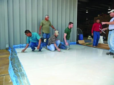 Mike Emma and Kurt Ziegler, kneeling on right, attended a skim coating class at the Decorative Concrete Institute four days after returning home from a tour of duty in Iraq.