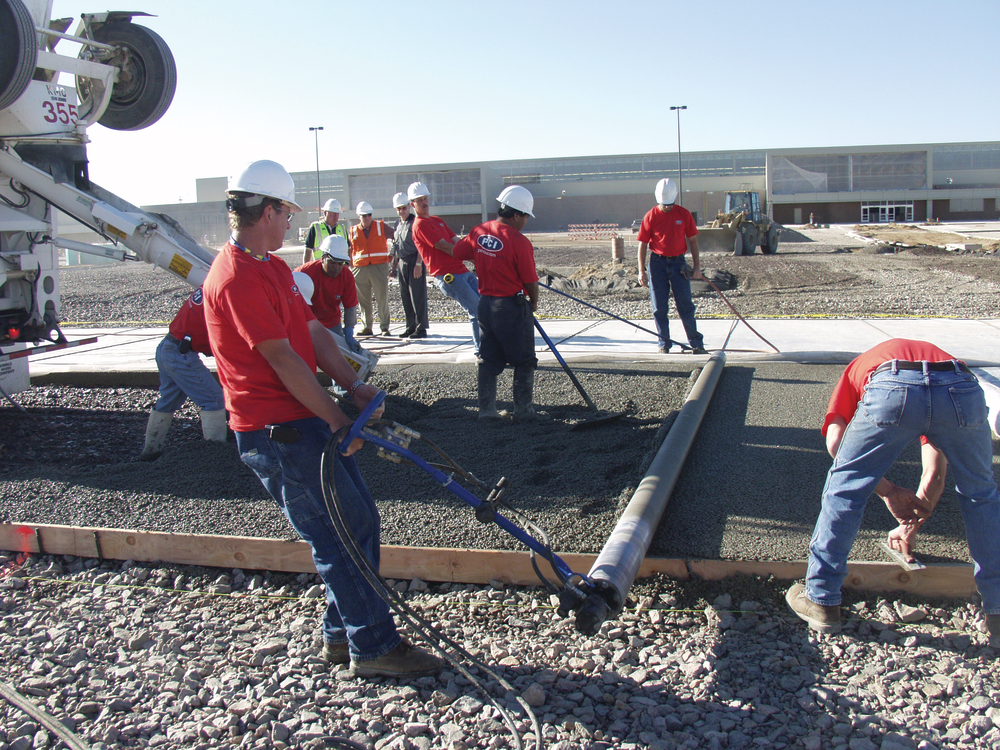 A pervious concrete pavement placement works like an assembly line, says Dale Fisher, with crew members working the ready-mixed truck's chute, members working the screed, and others following with finishing tools.