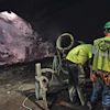 Workmen set up the DustBoss DB-60 on the blasting job for the 2nd Avenue Subway under Manhattan. Three of the machines, and one smaller unit, replace laborers with fire hoses, which would have cost the contractor up to $1 million per year on the job.