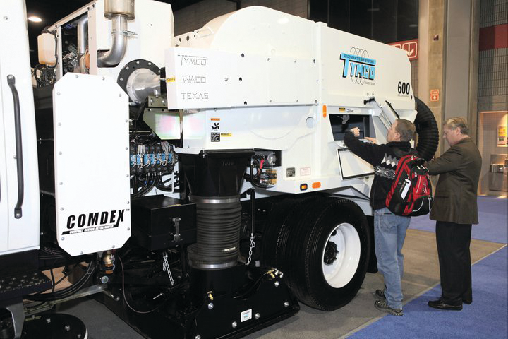 A contractor inspects a Tymco sweeper at NPE 2011 that was held in Nashville.