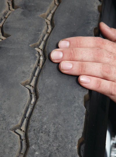 Examine the tread and feel the rubber with your fingertips for imperfections, irregular wear pattern or feathering of the tread blocks. Fingertips are very sensitive to changes in patterns and unusual wear.