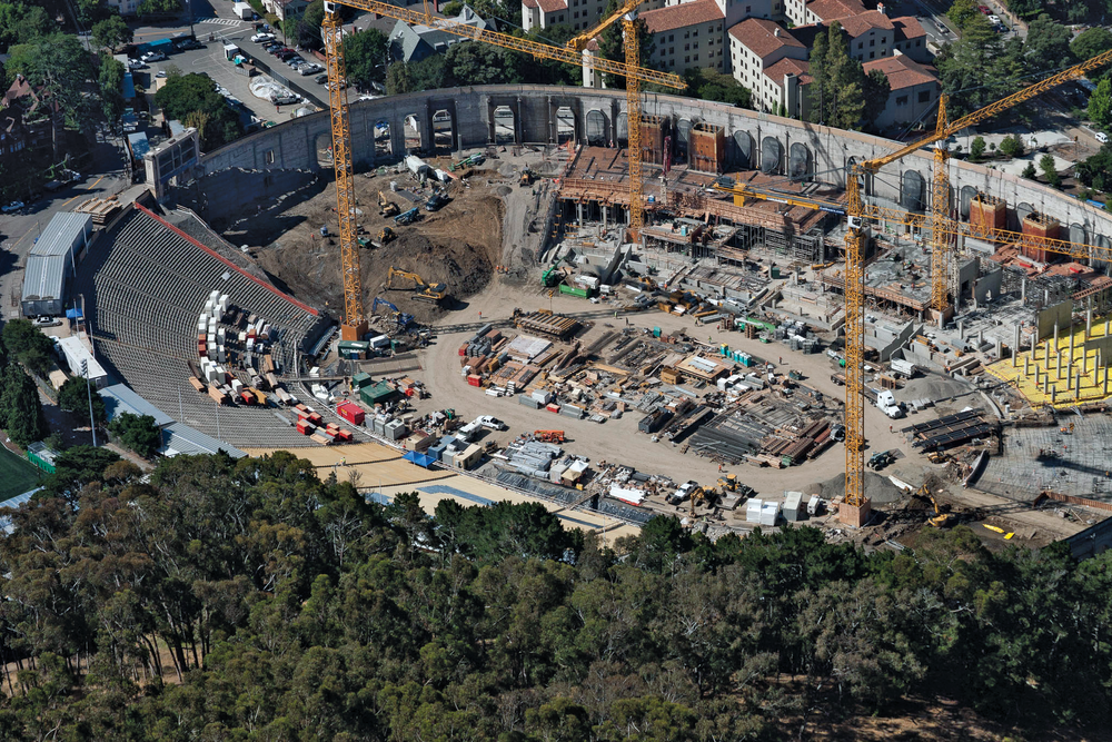 An aerial shot of Memorial Stadium shows site work taking place in the majority of the stadium and the original concrete facade around the structure.