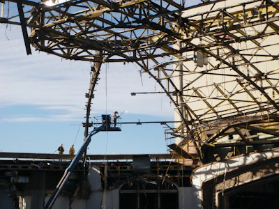 The dome's roofing materials - a compilation of over 16 inches of lightweight concrete, foam insulation, built-up roofing material and thin copper sheeting - were removed manually.