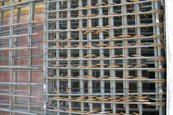Reinforcing steel is so congested in the shear wall boundary element (right side of photo) that concrete must be placed in the less heavily reinforced shear wall section (left side of photo) and vibrated at that point to move it laterally into the boundary element.