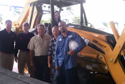 Case Community Challenge grand prize winner, Hubbard Construction received one year's free use of a Case 580N loader/backhoe. Pictured from left to right are Jim Bansen, Case territory sales manager; David Moore and Bob Ramos, Trekker Tractor; James Ankrum, Jr., Freddy Cruz and Gregoria Estrella (seated on the loader/backhoe), Hubbard Construction Company.