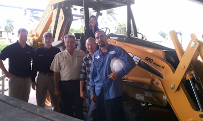 Case Community Challenge grand prize winner, Hubbard Construction received one year's free use of a Case 580N loader/backhoe. Pictured from left to right are Jim Bansen, Case territory sales manager; David Moore and Bob Ramos, Trekker Tractor; James Ankrum, Jr., Freddy Cruz and Gregoria Estrella (seated on the loader/backhoe), Hubbard Construction Company.