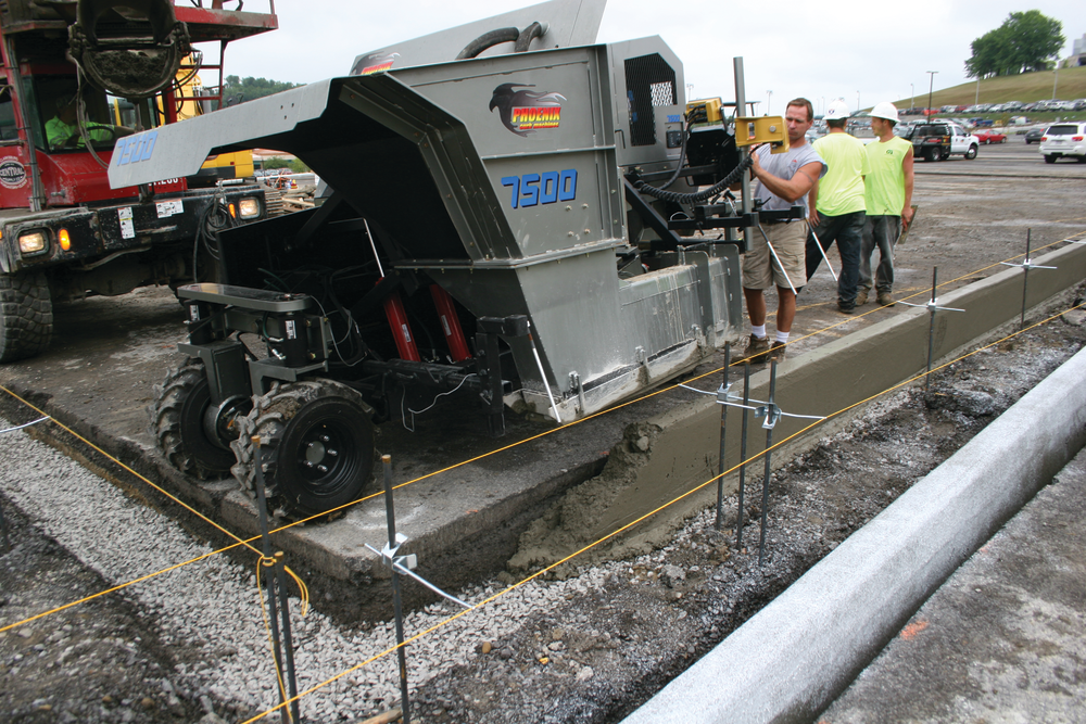 The mid-size curb and gutter machine pours close to the 90-degree transition point.