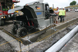 The mid-size curb and gutter machine pours close to the 90-degree transition point.