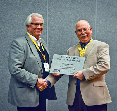 Bob Long (left), on behalf of Thermomass, accepts the 2013 Tilt-Up Concrete Association Robert Aiken Innovation Award from TCA Executive Director Ed Sauter (right).