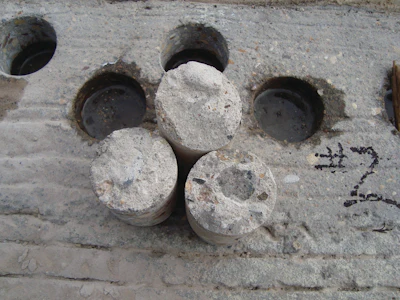 In-place concrete strengths represented by cores are typically less than lab-cured cylinder strengths due to field factors like consolidation and curing.