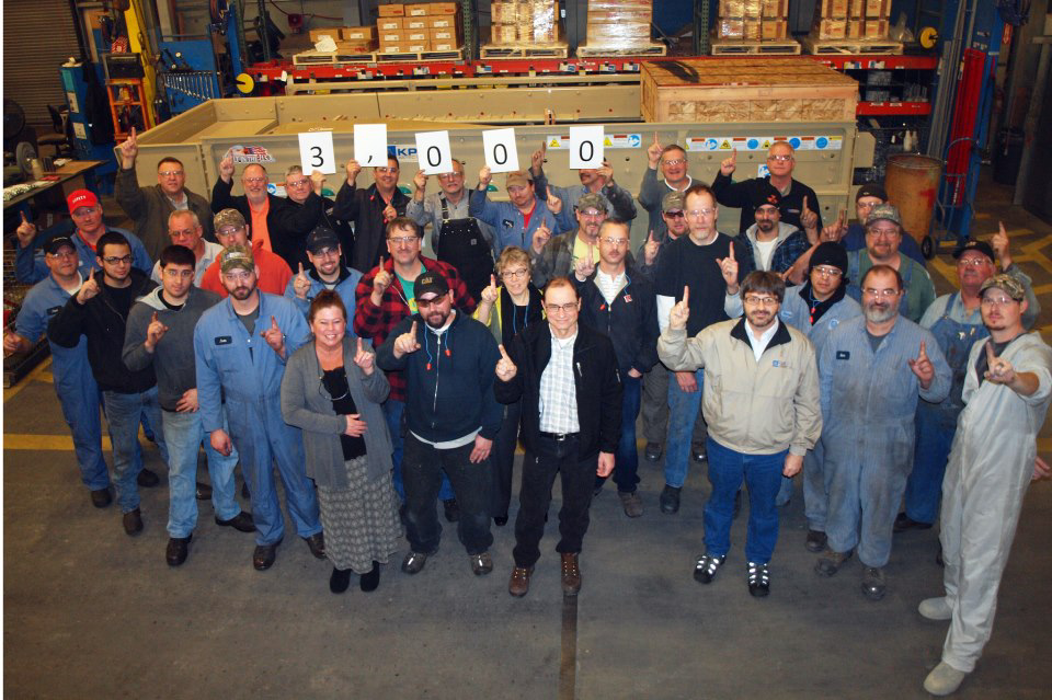 Johnson Crushers International Inc. employees celebrate the shipment of its 3,000th screen.