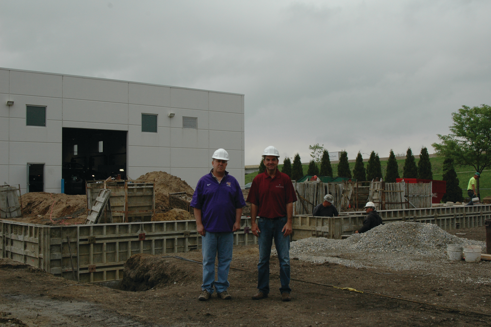 Scott and Dave Martinson, owners of Martinson Construction, on site at a project in Waterloo, Iowa, where their company is installing footings and a foundation for a car dealership addition.