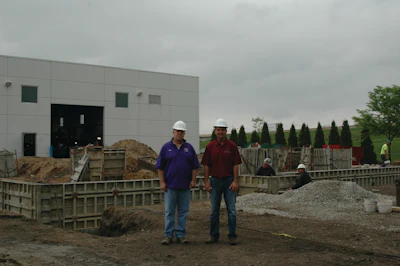 Scott and Dave Martinson, owners of Martinson Construction, on site at a project in Waterloo, Iowa, where their company is installing footings and a foundation for a car dealership addition.