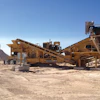 A concrete pile in the distance soon to be crushed and screened by the RDS-15, which will process the stack into several grades of usable material.