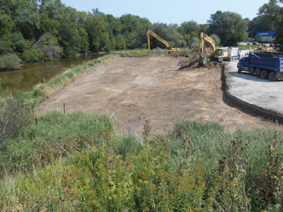 Schneider Excavating, Inc. was hired to excavate the plants and provide a finished grade suitable for replanting on the Sheboygan River riverbank in Wisconsin.