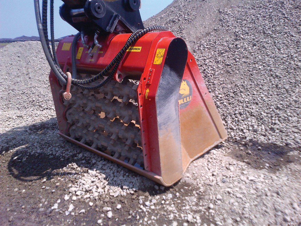 In some areas of the settling pond, previously excavated material is being mixed with a binding agent using two ALLU Screener Crushers.