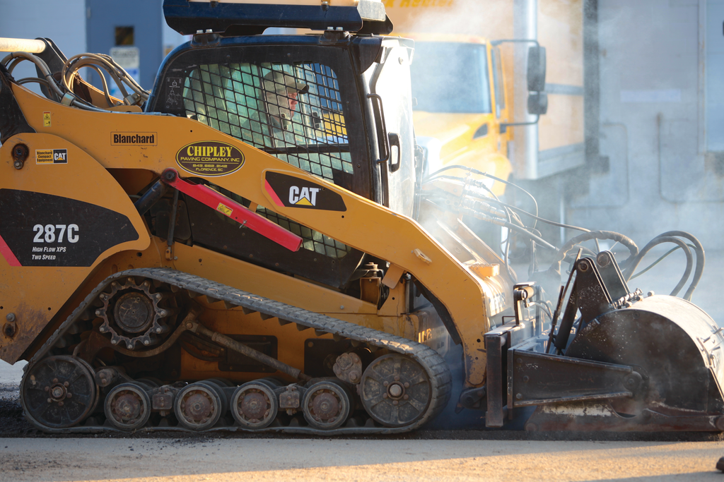 Chipley Company has three high-flow asphalt milling attachments that enable its track loaders to do prep work in parking lots and repair and maintenance of other paved surfaces.