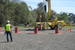 Crane Operator Skills Championship contestant navigates a suspended barrel through the Barrel Slalom at a qualifying event for the 2014 championship.