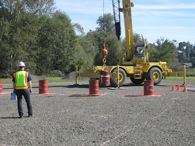 Crane Operator Skills Championship contestant navigates a suspended barrel through the Barrel Slalom at a qualifying event for the 2014 championship.