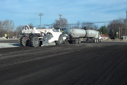 A reclaimer and emulsion tanker introduce emulsion to the RAP, placed on top of a cement-treated subgrade.