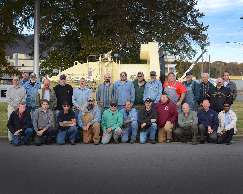 The Astec burner team gathers around the 500th burner built by Astec.