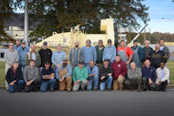 The Astec burner team gathers around the 500th burner built by Astec.