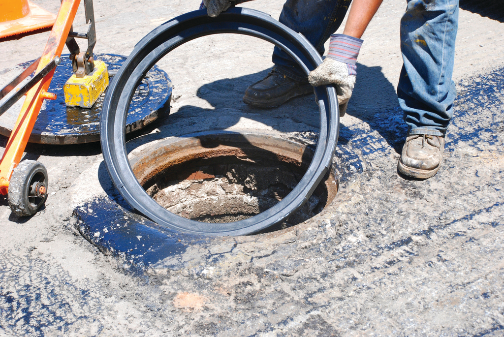 An FJ Turner adjustable riser being places during a City of San Diego overlay project.