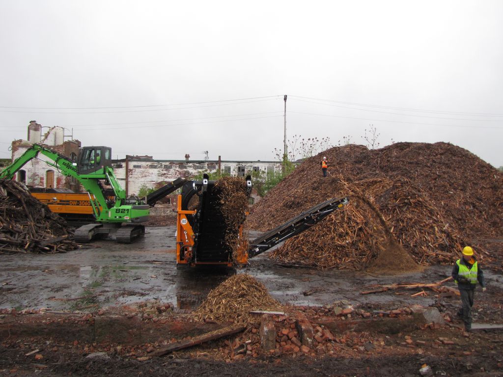 The Sennebogen 821 material handler feeds a pair of grinders as part of Costello Dismantling's efforts to maximize the revenues from demolition projects.