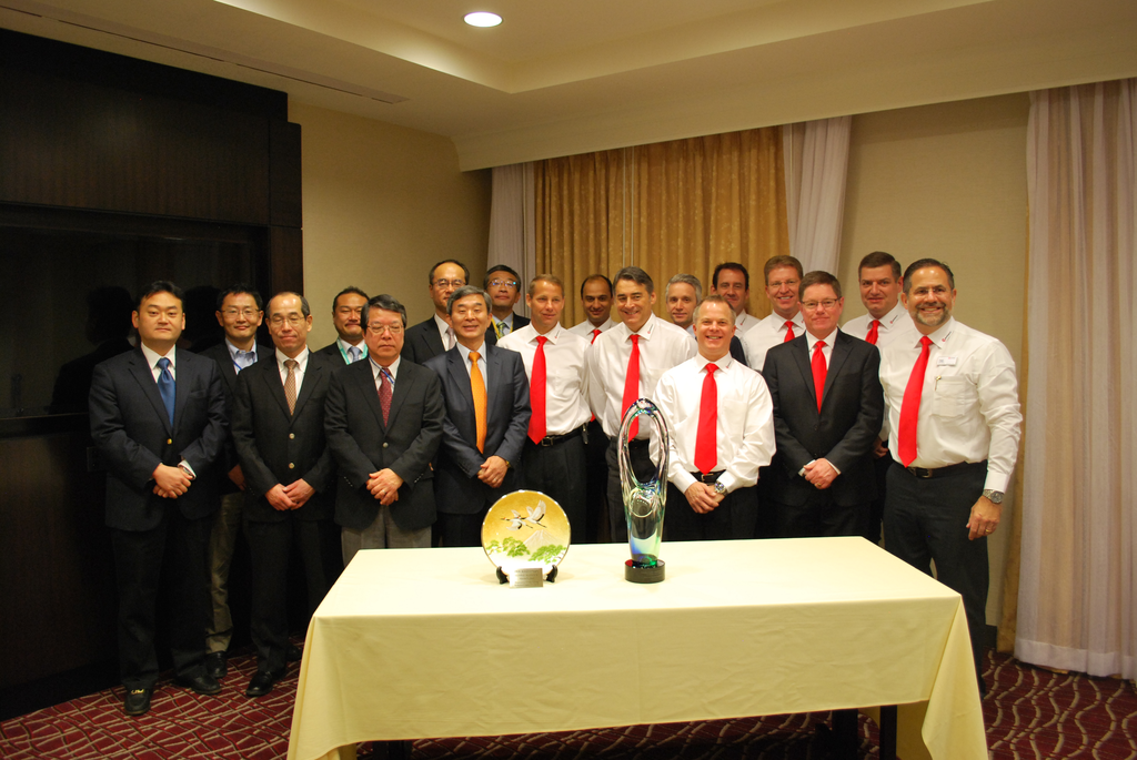 Eric Etchart, president of Manitowoc Cranes, and Asihiko Tsukamoto, president of Kobelco, celebrate with colleagues from both companies.
