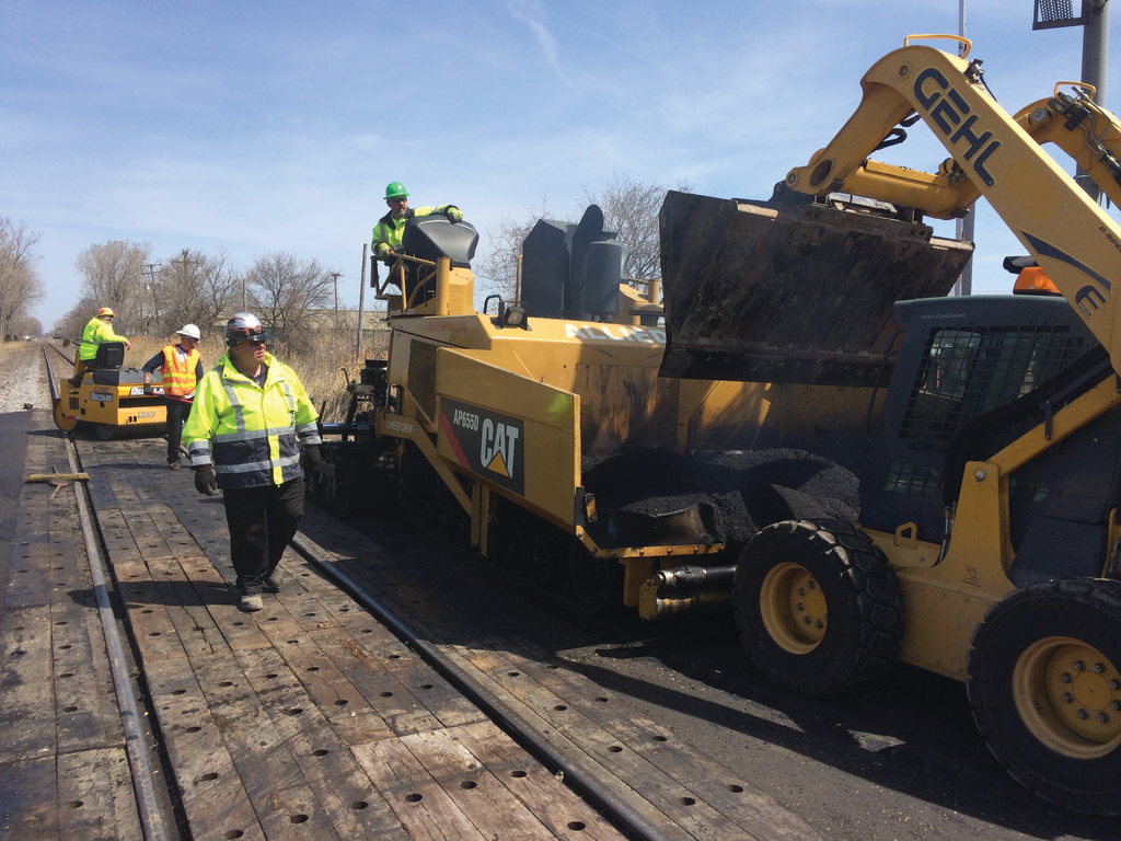 The material utilized in between the rails varies depending on local traffic volumes. In heavier industrial areas, the railroad will often spec a sturdier material such as wood.