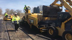 The material utilized in between the rails varies depending on local traffic volumes. In heavier industrial areas, the railroad will often spec a sturdier material such as wood.