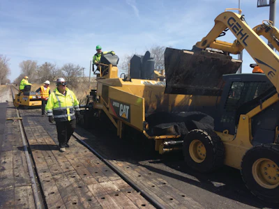 The material utilized in between the rails varies depending on local traffic volumes. In heavier industrial areas, the railroad will often spec a sturdier material such as wood.
