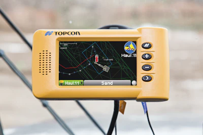 The HT-30 haul truck system features a small, portable GPS-enabled control box that mounts into the truck cab. As the truck is loaded, data about the load is input, such as material type, driver, and quantity.