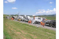 The roadwork train consisted of a water truck in front, emulsion tanker truck, Roadtec RX-900e cold planer, Roadtec RT-500 mobile recycle trailer, a Caterpillar paver, a Cat steel roller compactor and a Cat rubber tire compactor.