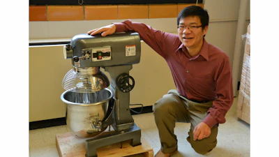 Xianming Shi with the industrial size mixer he uses to concoct green deicers and ice-free pavement.