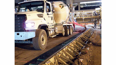 Transit mixers worked inside metal paving forms, sometimes hauling as many as 120 truckloads a night, to repave gate areas at Phoenix Sky Harbor International Airport.