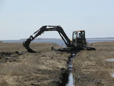 A Volvo ECR88 D-Series excavator fitted with unique swamp pads is working in the Connecticut coastal wetlands for the Wetlands Habitat and Mosquito Management (WHAMM) Program.