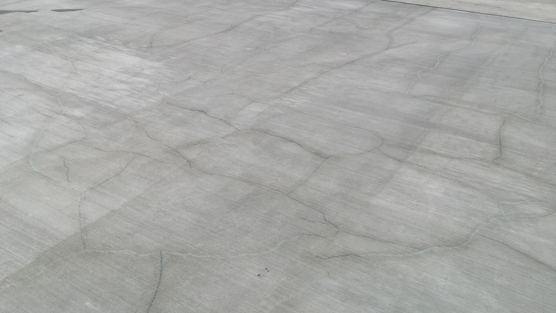 Random cracks in reinforced slabs caused by thermal contraction and drying shrinkage are not longitudinal cracks and typically do not increase the risk of reinforcement corrosion in concrete.