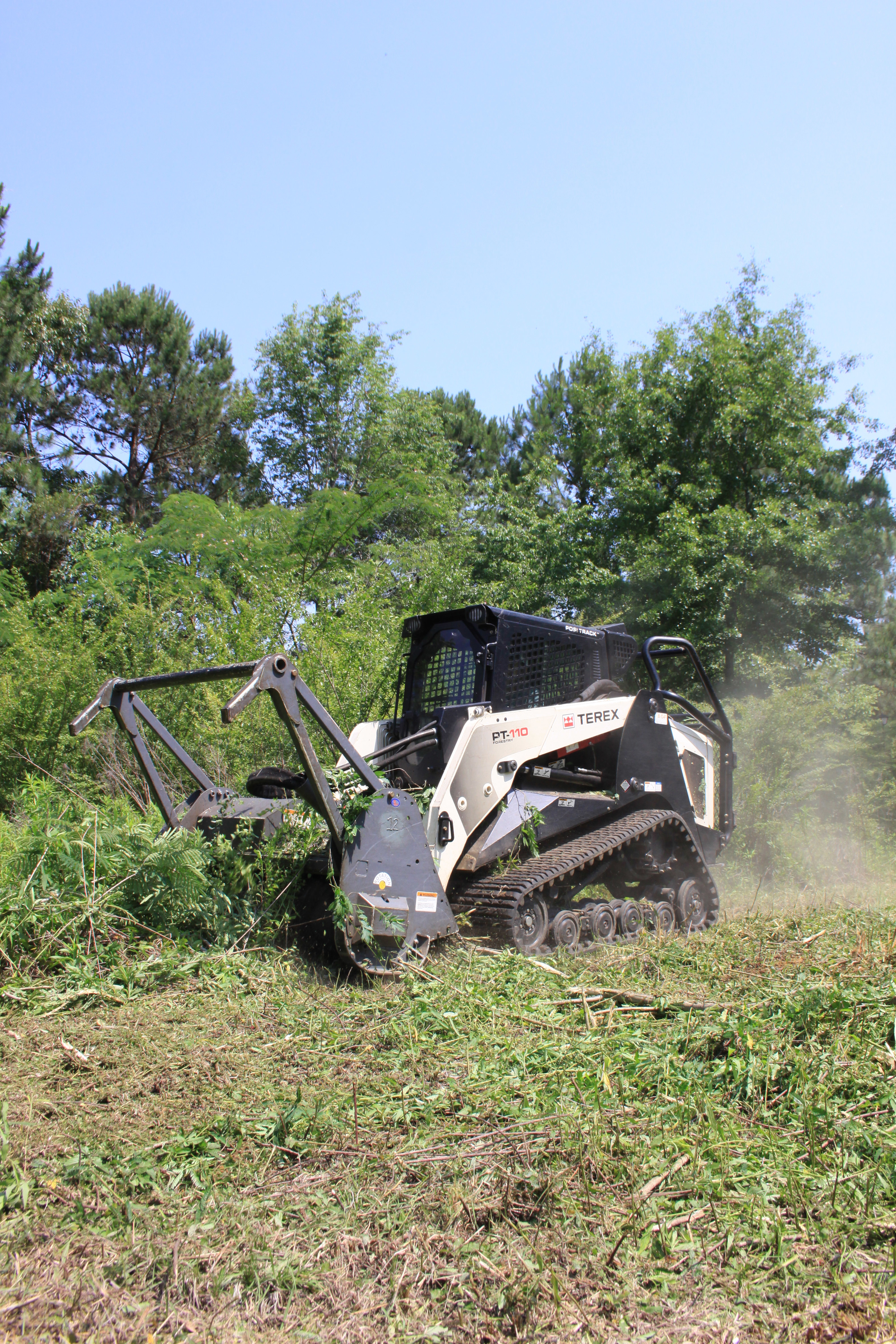 Surgical Land Clearing uses a 111-hp Terex PT-110 Forestry compact track loader with a Loftness brush cutter attachment to cut through undergrowth and trees up to 8 in. in diameter.