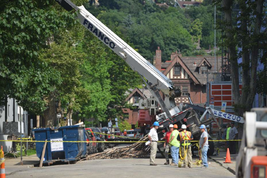 Worker error may be to blame after a crane tips over while lifting scaffolding.
