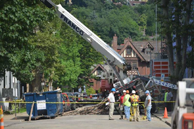 Worker error may be to blame after a crane tips over while lifting scaffolding.