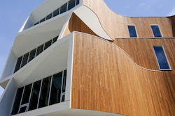 The building features distinct curves and apertures that make it standout visually as well as allow sunlight and shade to be optimized for the lighting and temperature, saving energy and enhancing comfort levels for occupants.