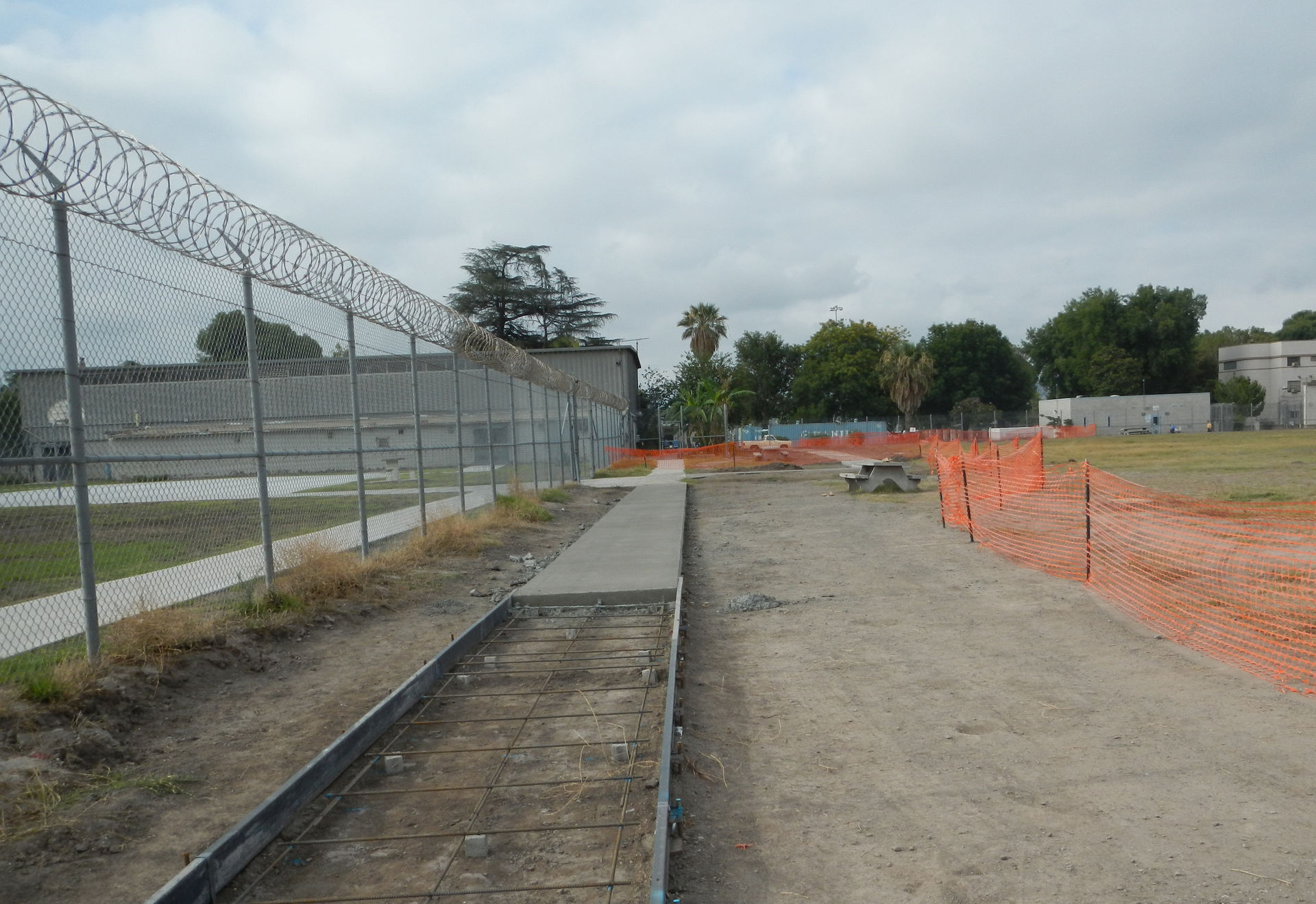 Partially completed sidewalk shows forms in place in foreground and removed in background