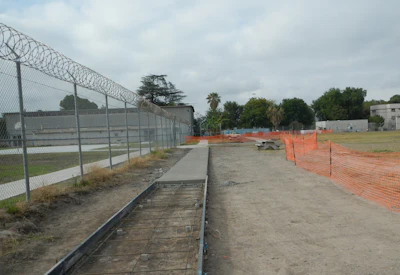 Partially completed sidewalk shows forms in place in foreground and removed in background